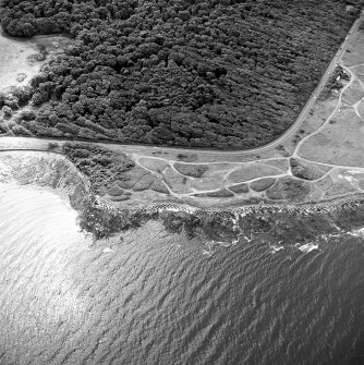 Oblique aerial view of Gosford Sands centred on the remains of anti-tank blocks, taken from the NW.