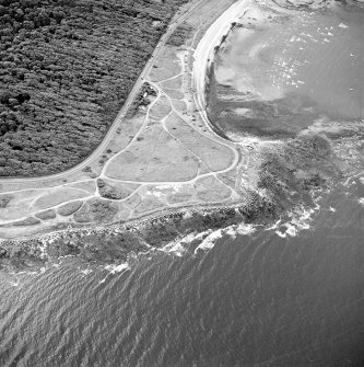 Oblique aerial view of Gosford Sands centred on the remains of anti-tank blocks, taken from the NW.