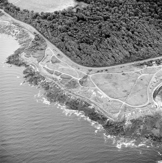 Oblique aerial view of Gosford Sands centred on the remains of anti-tank blocks, taken from the WNW.