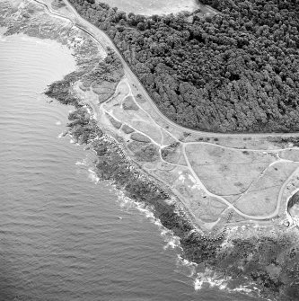 Oblique aerial view of Gosford Sands centred on the remains of anti-tank blocks, taken from the WNW.