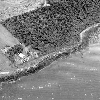 Oblique aerial view of Gosford Sands centred on the remains of anti-tank blocks, taken from the WNW.