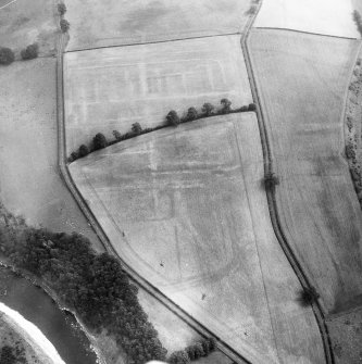 Newstead, Roman fort and temporary camps: air photograph showing fort (NT 569 344), Southern annexe (NT 569 341), Eastern annexe (NT 572 343), Western annexe (NT 567 343), annexe (NT 571 343), possible annexe (NT 570 346), and 160-acre temporary camp (NT 567 337).
