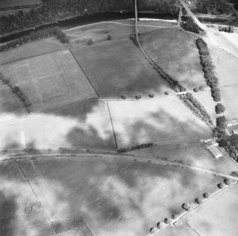 Newstead, Roman fort and temporary camps: air photograph showing fort (NT 569 344), Southern annexe (NT 569 341), Eastern annexe (NT 572 343), annexe (NT 571 343), possible annexe (NT 570 346) and 'Great camp' complex of temporary camps (NT 574 341).

