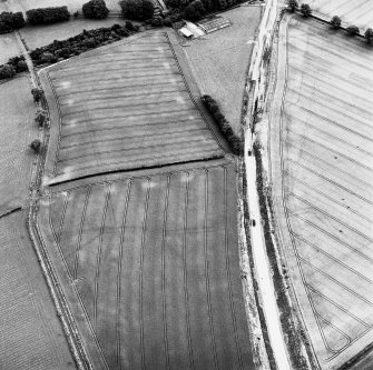 Newstead, oblique aerial view, taken from the W, centred on the southern annexe and a temporary camp. The Newstead by-pass (under construction) runs across the photograph.