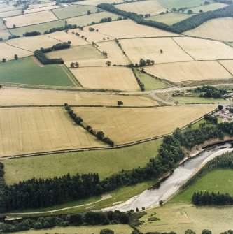 Oblique aerial view of Newstead centred on the cropmarks of the Roman fort, southern and western annexes, taken from the SW.