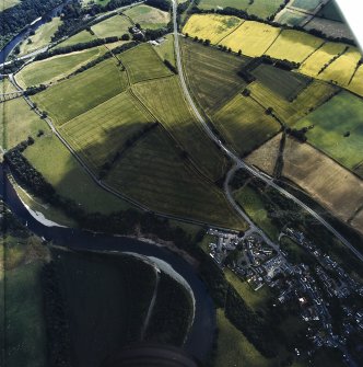 Oblique aerial view centred on the cropmarks of the Roman fort, annexes and temporary camps with the enclosure adjacent, taken from the WNW.