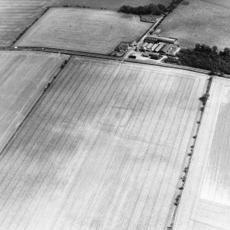 Oblique aerial view of Huntington centred on the cropmarks of a settlement and barrow, taken from the SW.
