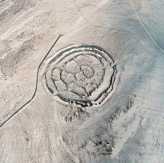 Oblique aerial view of Longcroft centred on the remains of fort, settlement, cultivation remains and cord rig, taken from the S.