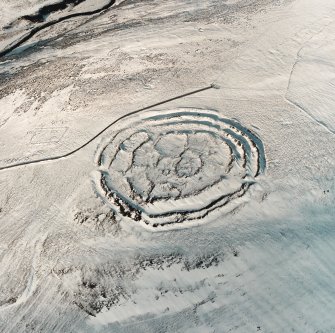 Oblique aerial view of Longcroft centred on the remains of fort, settlement, cultivation remains and cord rig, taken from the SSE.