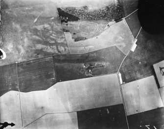 Vertical aerial view of The Chesters, Drem showing the fort, a circular palisaded settlement and the W end of a settlement.