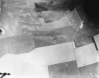 Vertical aerial view of The Chesters, Drem showing the fort, a circular palisaded settlement, a pit-alignment and the W end of a settlement.
