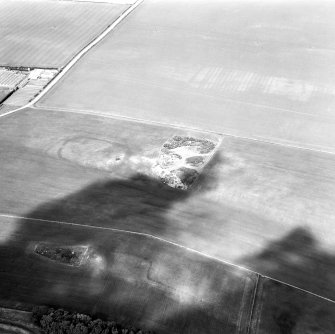 Oblique aerial view showing Foster Law, settlement and The Chesters, pit-alignment cropmarks.
