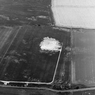 Oblique aerial view centred on the excavation of the settlement, taken from the SSE.