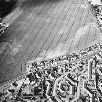 Oblique aerial view of cropmarks including linear croparks and pits, taken from the SW.