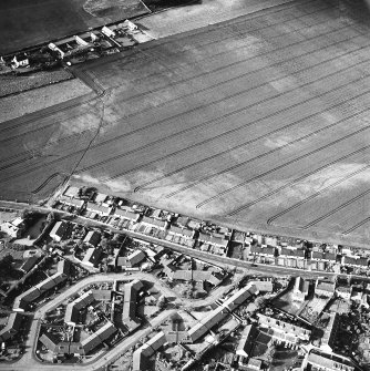 Oblique aerial view of cropmarks including linear croparks and pits, taken from the SW.