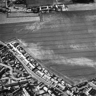 Oblique aerial view of cropmarks including linear croparks and pits, taken from the SSE.