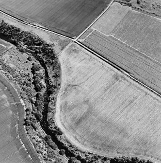 Oblique aerial view of Hailes Smithy centred on the cropmark of a possible enclosure.  Taken from the WNW.