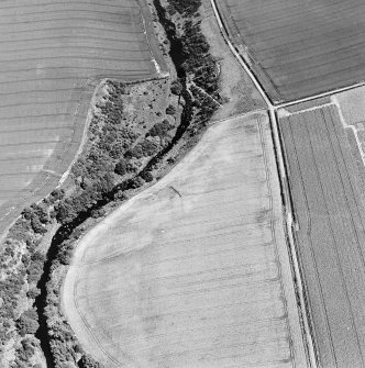 Oblique aerial view of Hailes Smithy centred on the cropmark of a possible enclosure.  Taken from the E.