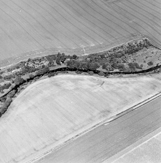 Oblique aerial view of Hailes Smithy centred on the cropmark of a possible enclosure.  Taken from the SSW.