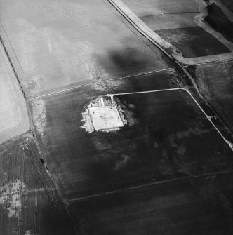 Oblique aerial view centred on the excavation of the settlement, taken from the W.