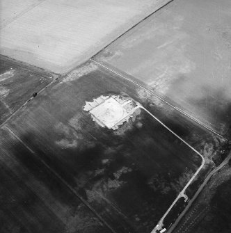 Oblique aerial view centred on the excavation of the settlement, taken from the SW.