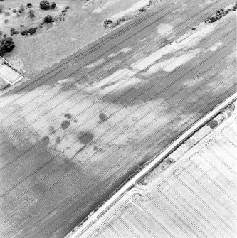 Congalton, oblique aerial view, taken from the SW, centred on cropmarks including a ring-ditch, an enclosure, and a series of indeterminate marks.