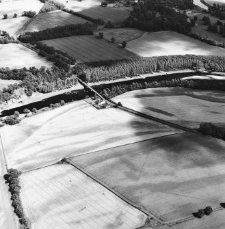 Mertoun Bridge, obique aerial view, taken from the W, centred on the cropmarks of a Roman Temporary Camp.