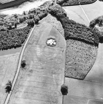 Brox Law, oblique aerial view, taken from the NE, centred on the cropmark of a fort which is partially overlain by a pond.
