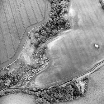 Oblique aerial view centred on the cropmarks of the enclosure with dovecot adjacent, taken from the NW.