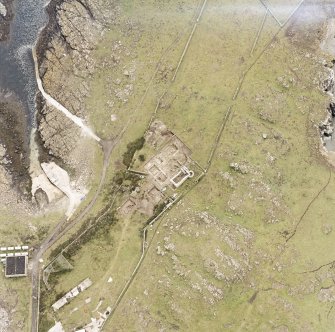 Isle of May, St Adrian's Chapel, oblique aerial view, taken from the NW, centred on the priory and the excavations, and on the remains of a village.