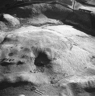 Oblique aerial view centred on the remains of the cord rig with building and enclosures adjacent, taken from the N.