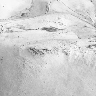 Woden Law, fort and associated monuments: air photograph under snow.
RCAHMS, 1992.
