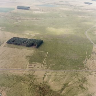 Pennymuir, oblique aerial view, taken from the ENE, centred on three Roman Temporary Camps, a linear earthwork and an area of rig. The course of 'Dere Street' is visible in the bottom half of the photograph.