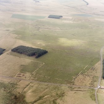 Pennymuir, oblique aerial view, taken from the NE, centred on three Roman Temporary Camps, a linear earthwork and an area of rig. The course of 'Dere Street' is visible in the bottom half of the photograph.