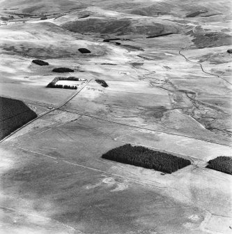 Pennymuir, oblique aerial view, taken from the SW, centred on Roman Temporary Camps, a linear earthwork and an area of rig. The course of 'Dere Street' is shown in the centre of the photograph.