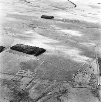 Pennymuir, oblique aerial view, taken from the WNW, centred on three Roman Temporary Camps, a linear earthwork and an area of rig. The course of 'Dere Street' is visible in the bottom half of the photograph.