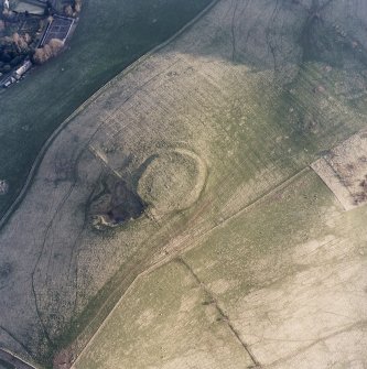 Oblique aerial view centred on the remains of the fort and quarry, taken from the N.