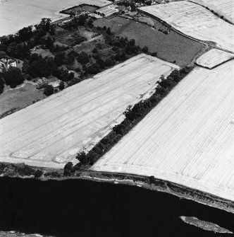 Oblique aerial view of Springhill centred on the cropmarks of a fort, taken from the SW.