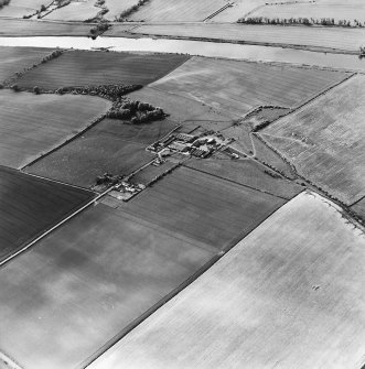 Oblique aerial view centred on the farmsteading with deserted medieval village and rig adjacent, taken from the E
