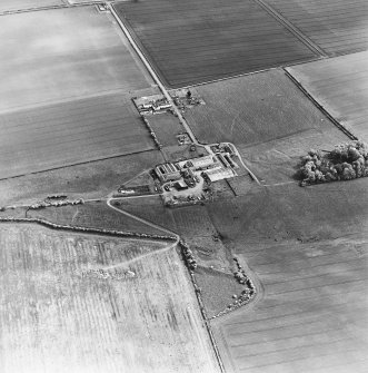 Oblique aerial view centred on the farmsteading with deserted medieval village and rig adjacent, taken from the NNW