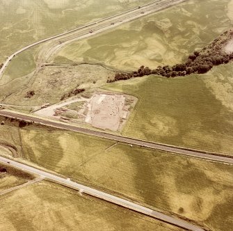 Oblique aerial view showing the excavation of a palisaded enclosure.