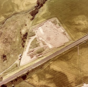 Oblique aerial view showing the excavation of a palisaded enclosure.