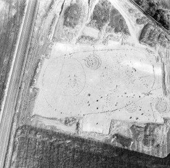 Oblique aerial view showing the excavation of a palisaded enclosure.