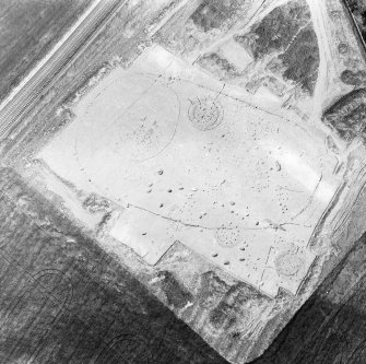 Oblique aerial view showing the excavation of a palisaded enclosure.