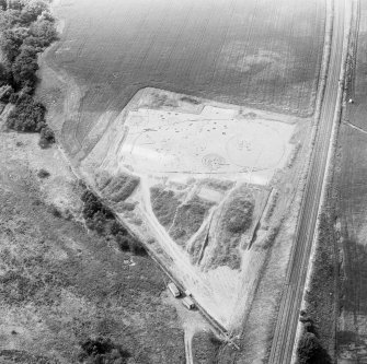 Oblique aerial view showing the excavation of a palisaded enclosure.