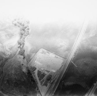 Oblique aerial view showing the excavation of a palisaded enclosure.