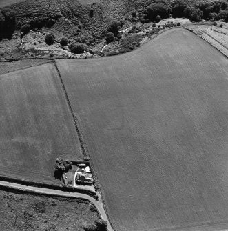 Oblique aerial view of Thornton Law centred on the cropmark of an enclosure.  Taken from the NE.