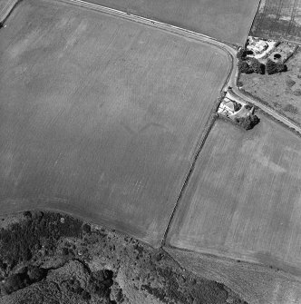 Oblique aerial view of Thornton Law centred on the cropmark of an enclosure.  Taken from the S.