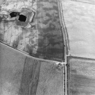 Oblique aerial view centred on the cropmarks of the settlements, taken from the WSW.