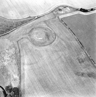 Oblique aerial view centred on the remains of the motte-and-bailey castle, taken from the S.